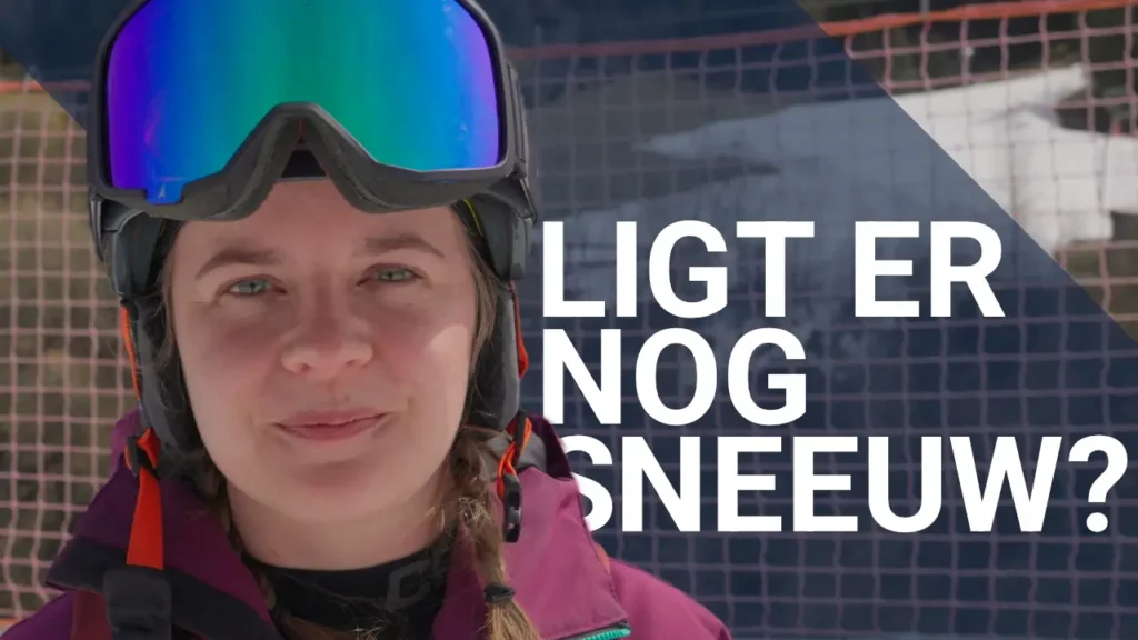 Vrouwelijke snowboarder met tekst: ligt er nog sneeuw?