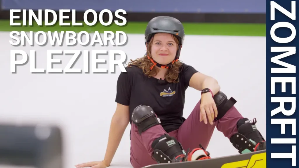 Vrouwelijke snowboarder zittend op de rolpiste. Zomerfit: eindeloos snowboardplezier.